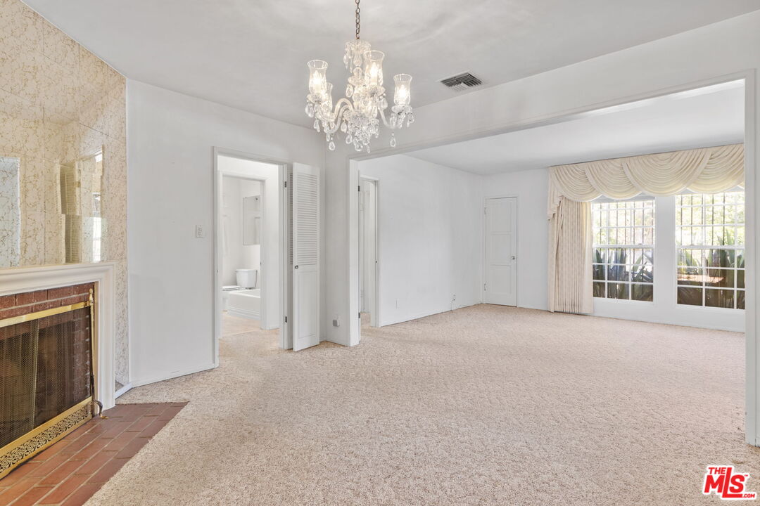 6900 Corbin Avenue Reseda, CA 91335 - Photo 7 of 35 a view of an empty room with chandelier and a window