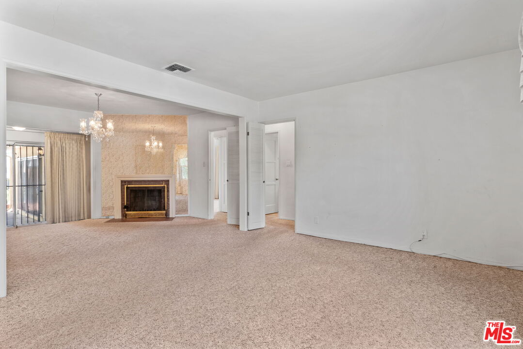 6900 Corbin Avenue Reseda, CA 91335 - Photo 10 of 35 an empty room with fireplace and a window