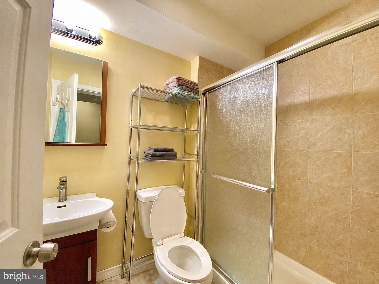 1618 Page Street, Unit A Philadelphia, PA 19121 - Photo 12 of 21 a bathroom with a granite countertop toilet sink and shower