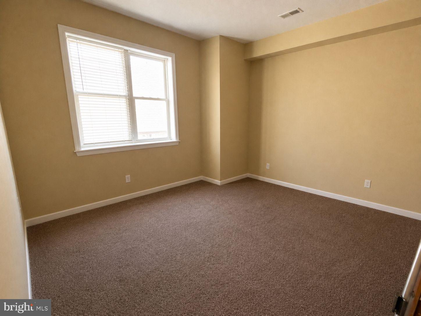 1618 Page Street, Unit A Philadelphia, PA 19121 - Photo 18 of 21 an empty room with a window