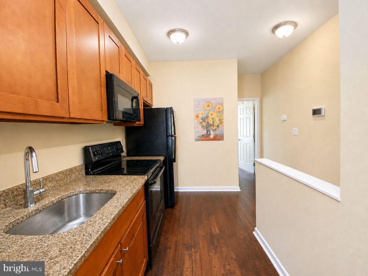 1618 Page Street, Unit A Philadelphia, PA 19121 - Photo 2 of 21 a kitchen with stainless steel appliances granite countertop a refrigerator a sink dishwasher a stove with wooden floor