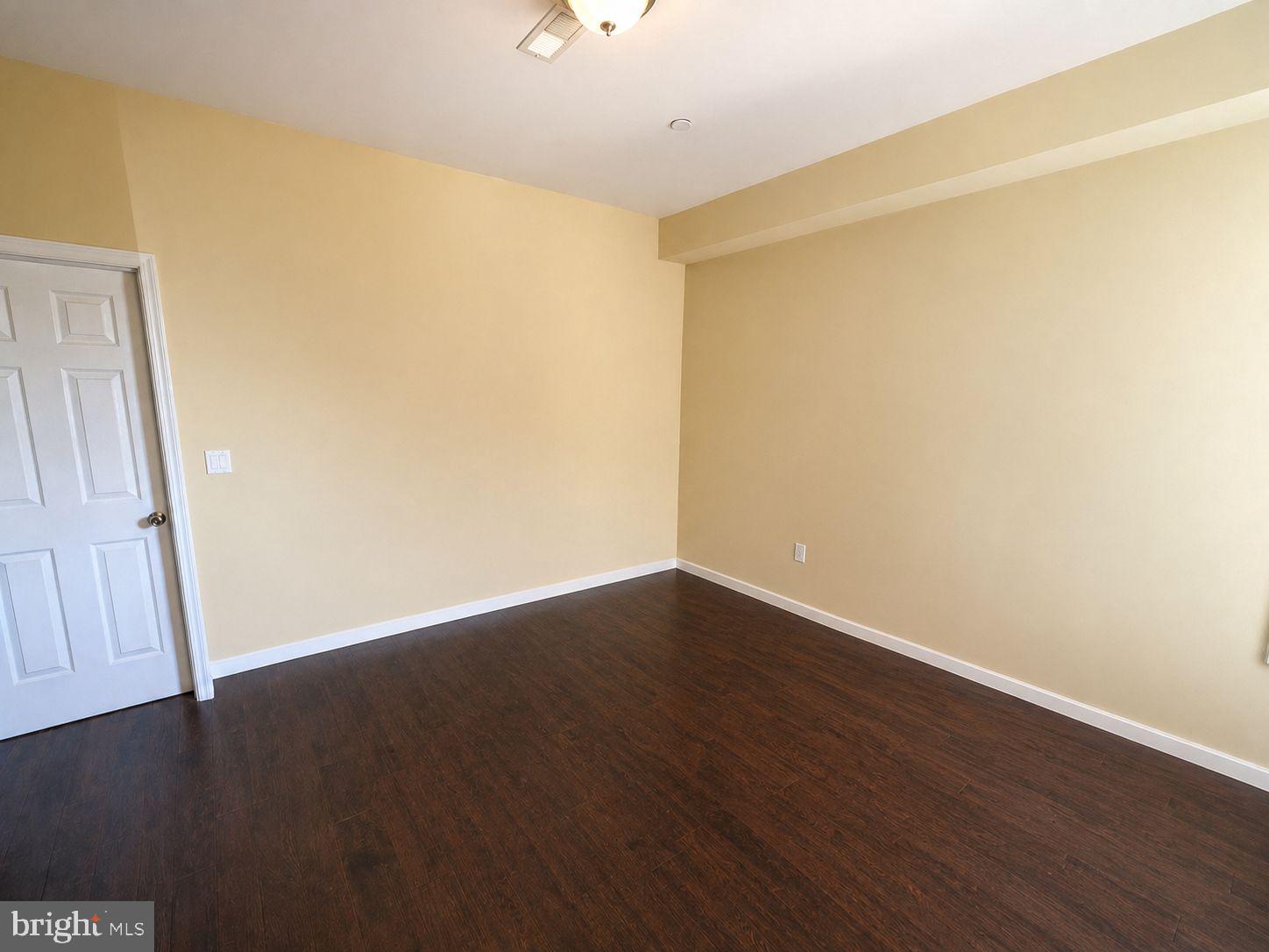 1618 Page Street, Unit A Philadelphia, PA 19121 - Photo 6 of 21 a view of an empty room with wooden floor