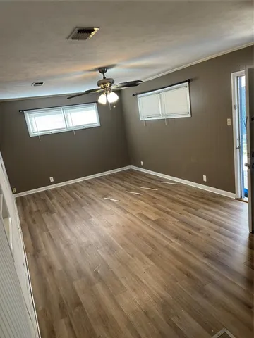 a view of empty room with wooden floor