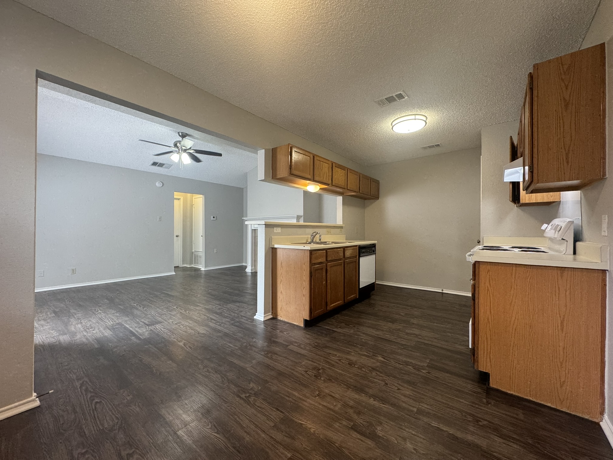 522 Cutty Trail, Unit B Lakeway, TX 78734 - Photo 20 of 20 An open floor plan with rich wood flooring connects the kitchen and living spaces seamlessly.