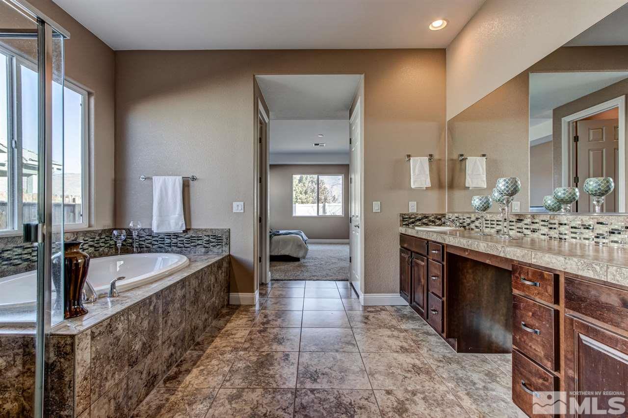 10060 Gold Cup Lane Reno, NV 89521 - Photo 15 of 25 a spacious bathroom with a bathtub sink and mirror