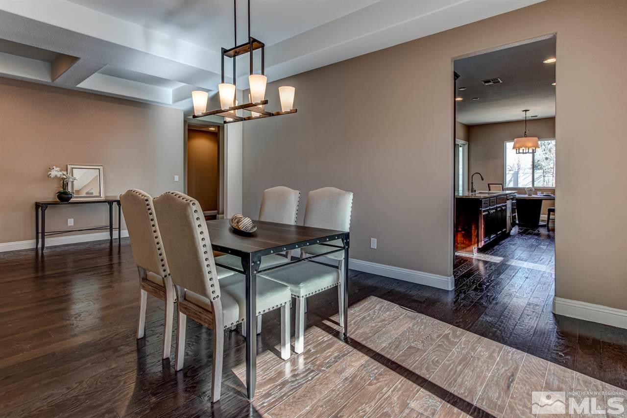 10060 Gold Cup Lane Reno, NV 89521 - Photo 4 of 25 a dining room with wooden floor a chandelier a wooden table and chairs