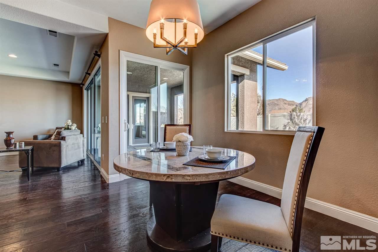 10060 Gold Cup Lane Reno, NV 89521 - Photo 8 of 25 a dining room with furniture a chandelier and wooden floor