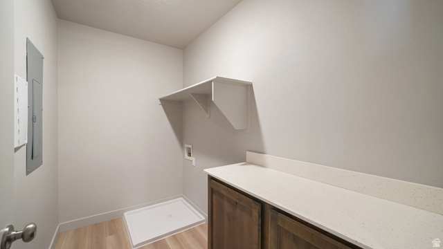 1223 East 1775 North Payson, UT 84651 - Photo 37 of 45 Utility room featuring wood-finish flooring, white walls, and a built-in shelf