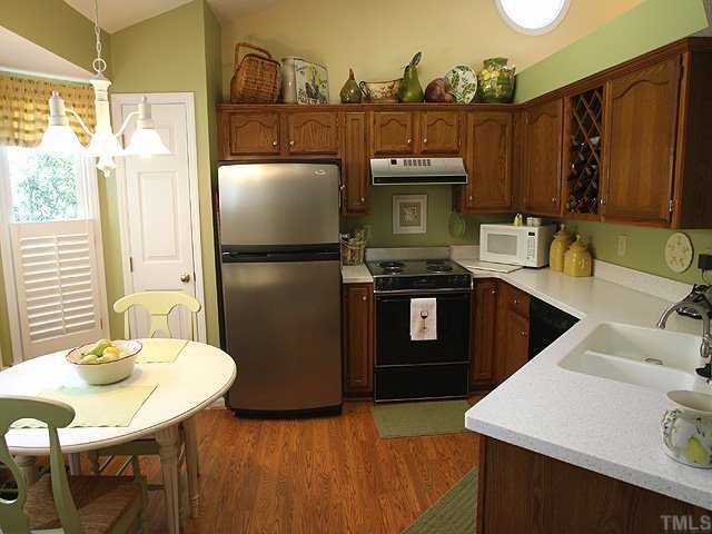 Perfect kitchen for the entertaining host or hostess with an eat-in area, pantry, solid surface countertops,wine rack, and openings to the dining and living area. Must see!