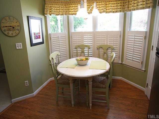 Grab a quick breakfast or sit with a cup of coffee and the morning paper in this breakfast nook surrounded by windows with plantation shutters.