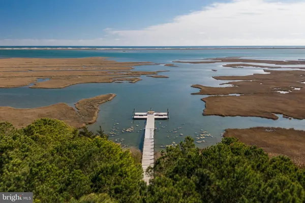 an aerial view of a houses with ocean view