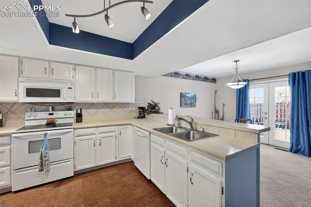 a kitchen with stainless steel appliances a stove a refrigerator and cabinets