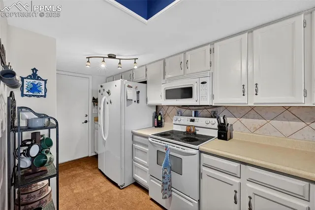 a bathroom with a granite countertop sink mirror vanity and toilet