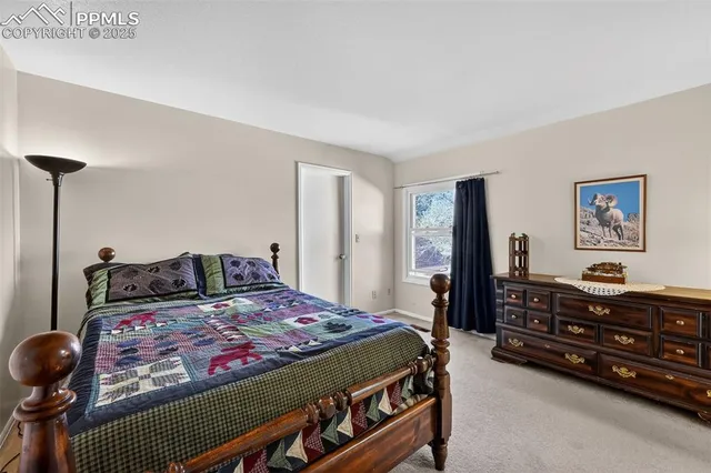 a bedroom with a bed and a night stand