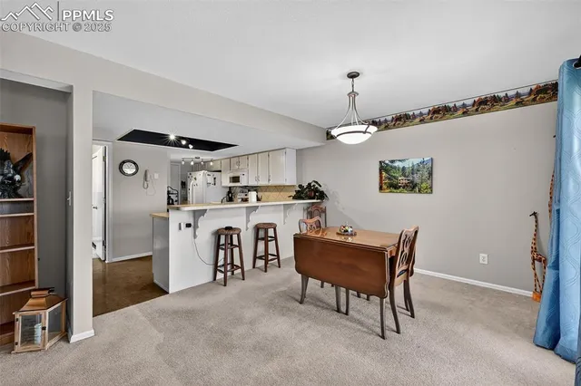 a workspace with furniture and a chandelier