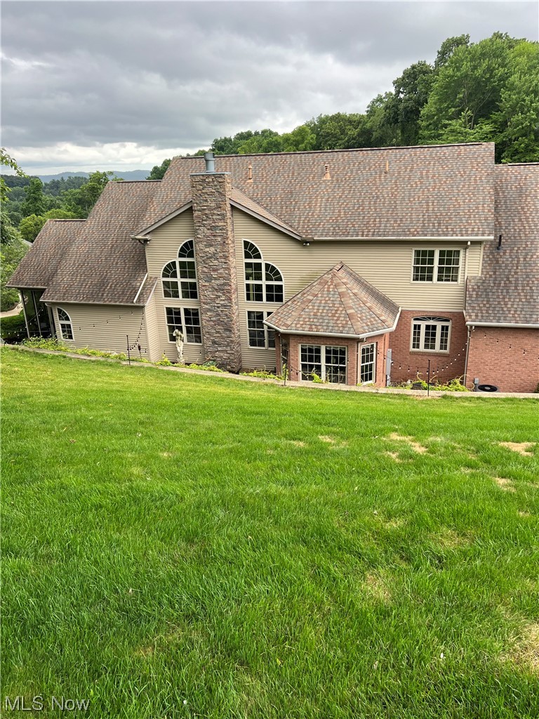 1457 Terrace Road Northwest New Philadelphia, OH 44663 - Photo 28 of 33 Back of house featuring a lawn