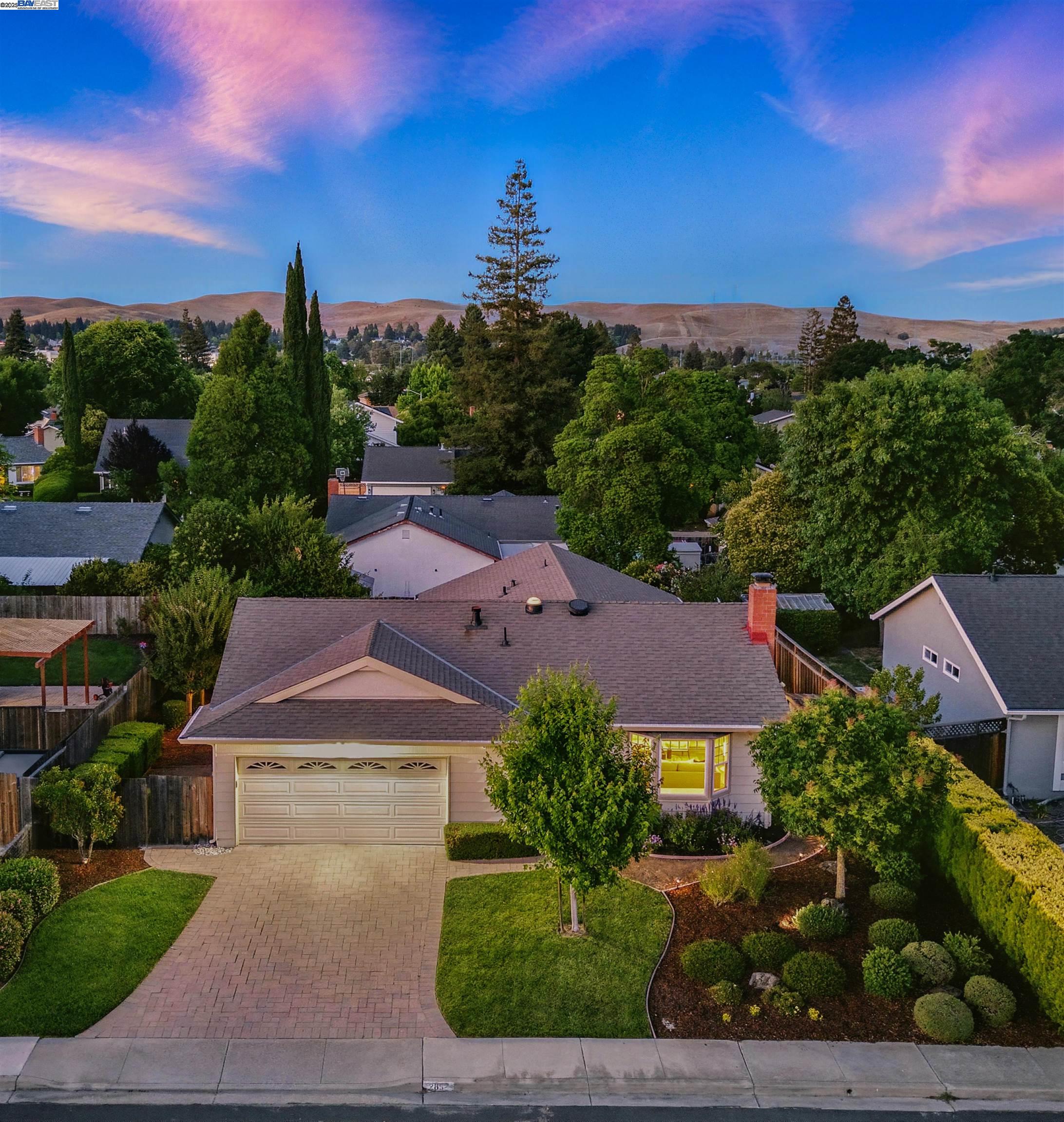 an aerial view of multiple houses with a yard