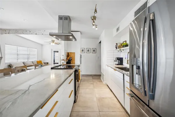 a large kitchen with a large counter top appliances and cabinets