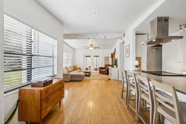 a living room with furniture windows and wooden floor