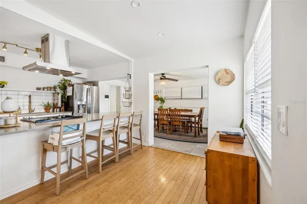 a view of a kitchen with furniture and wooden floor