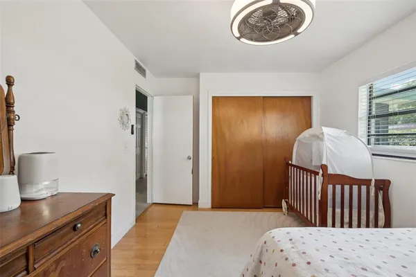 a bedroom with a bed and a window