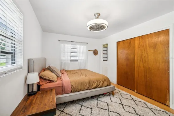 a bedroom with a bed and a window