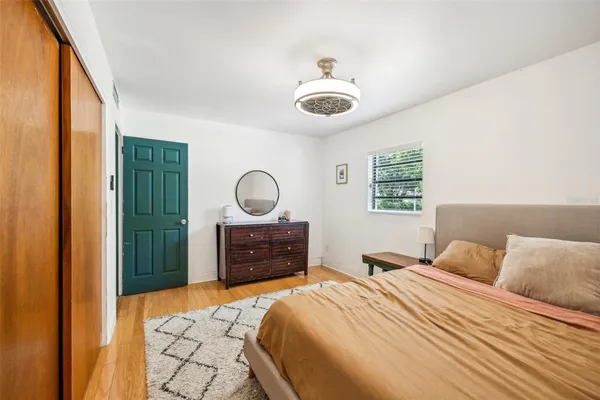 a bedroom with a bed and a dresser