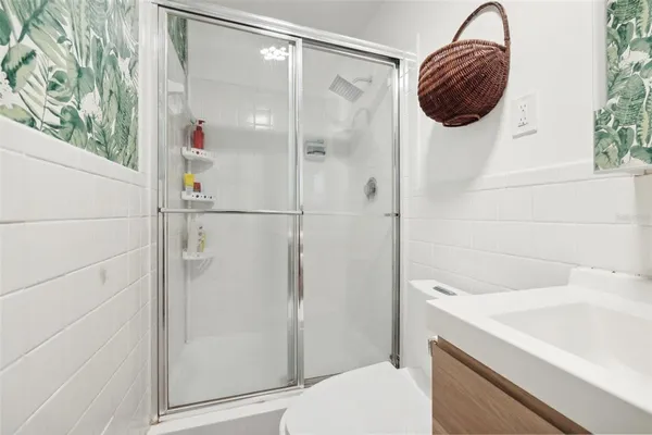 a bathroom with a shower and a sink
