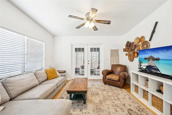 a living room with furniture a rug and a window