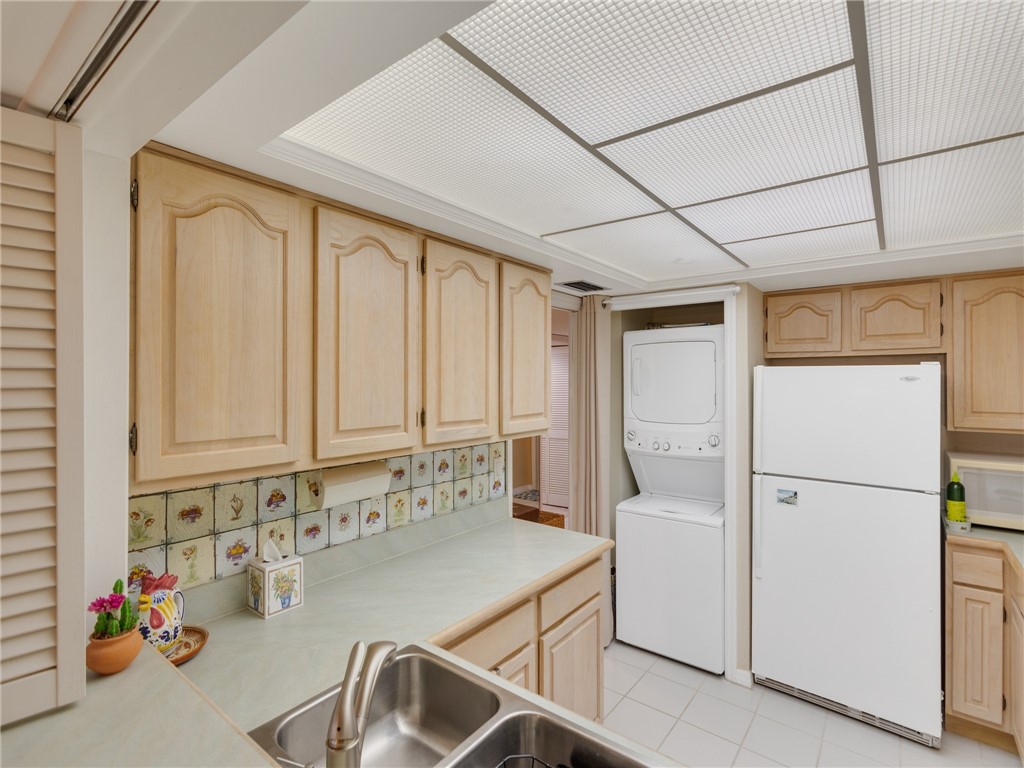 1880 Bay Road, Unit I319 Vero Beach, FL 32963 - Photo 14 of 36 a kitchen with a refrigerator a sink and cabinets