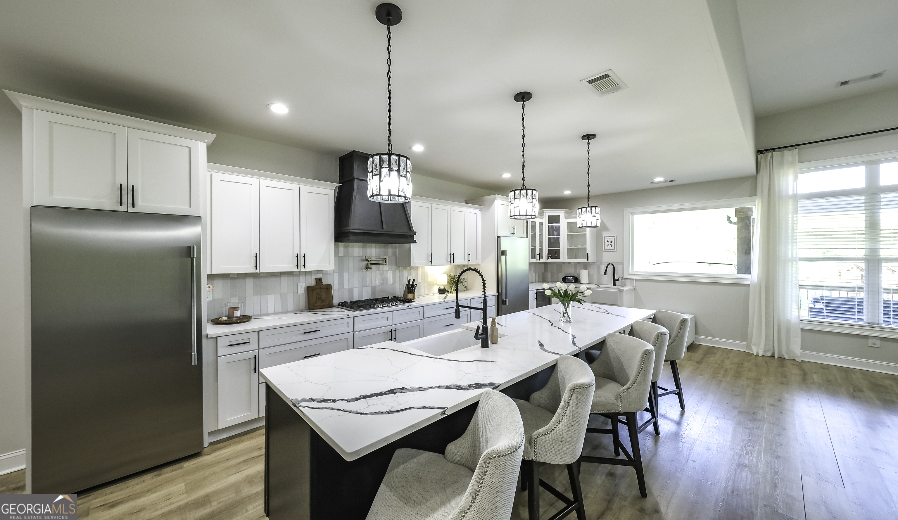 2392 Welcome Road Roopville, GA 30170 - Photo 13 of 43 a kitchen with stainless steel appliances granite countertop a dining table chairs and refrigerator