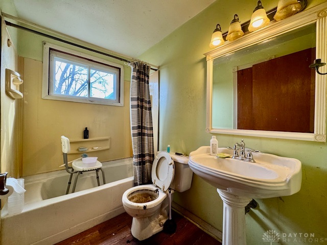 4733 Curtis Drive Springfield, OH 45503 - Photo 23 of 50 This bathroom features a classic pedestal sink, a bathtub, and a window for natural light.