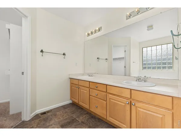 a bathroom with a granite countertop sink mirror and cabinets