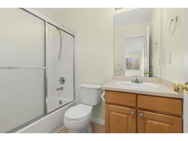 a bathroom with a sink toilet vanity and shower