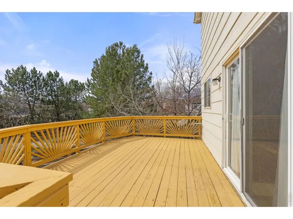 a view of balcony with wooden floor and fence