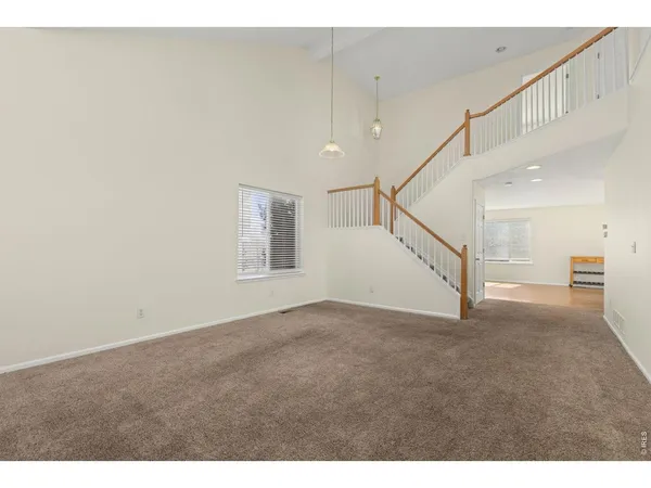 a view of an empty room with stairs