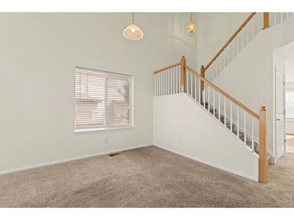 a view of an empty room with stairs