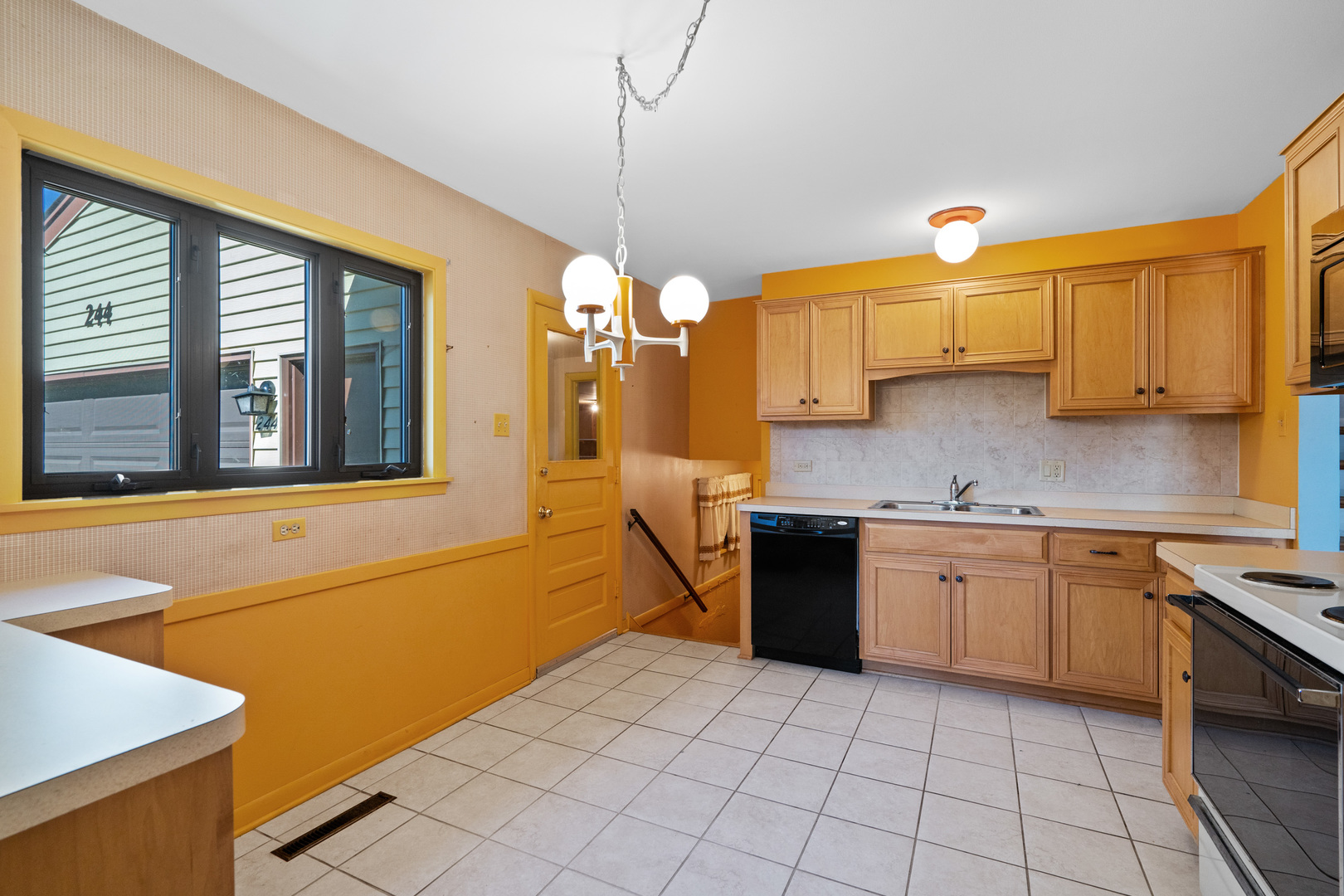 244 Thomas Street Park Forest, IL 60466 - Photo 10 of 30 a kitchen with stainless steel appliances granite countertop a sink and cabinets