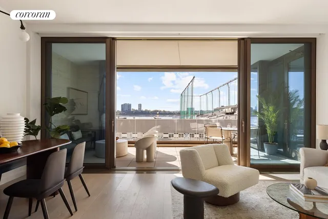 a living room with furniture and a floor to ceiling window