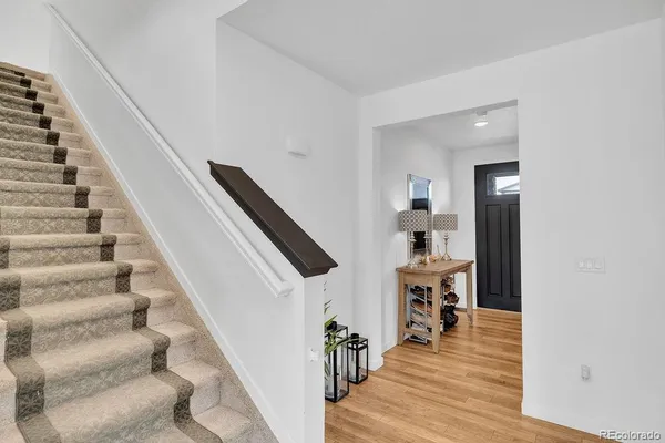 a view of entryway and hall with wooden floor