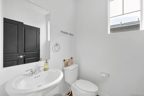 a bathroom with a sink a toilet and mirror