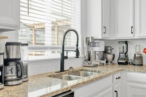 a kitchen with granite countertop a sink and a window