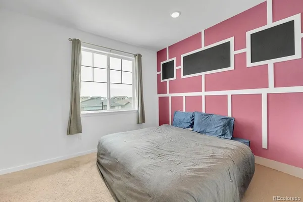 a bedroom with a bed and window