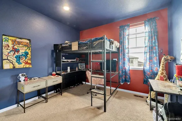 a bedroom with furniture and a window