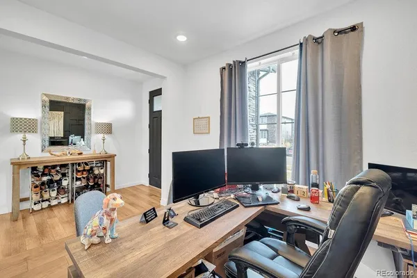 a view of a workspace with furniture and a flat screen tv