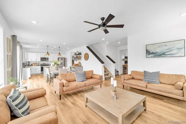 a living room with furniture and a view of kitchen