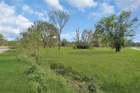 a view of grassy field with trees