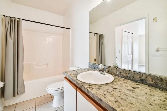 a kitchen with granite countertop a stove sink and cabinets