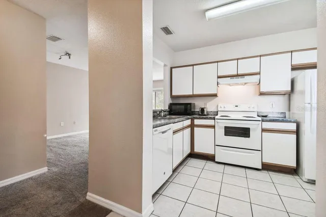 a kitchen with a sink and a microwave