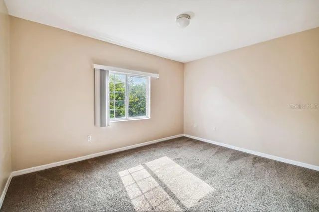 an empty room with sliding glass door